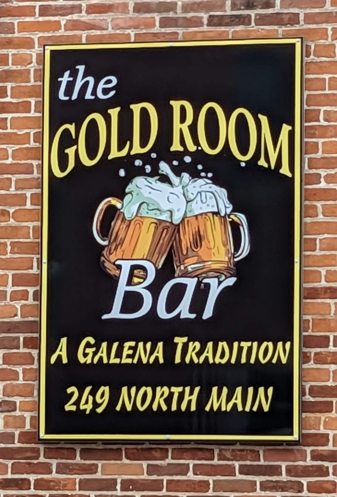 Sign on side of building that says, "The Gold Room Bar, A Galena Tradition, 249 North Main"